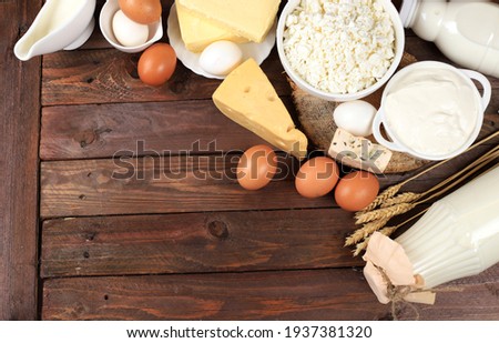 Assortment of fresh dairy products, healthy breakfast with ingredients, natural nutrition concept, maintaining healthy intestinal microflora, top view, rustic table,