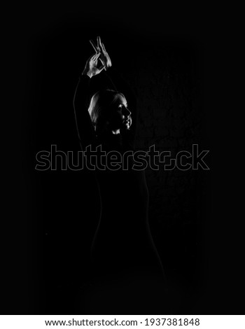 Black and white photography silhouette of a dancing woman.