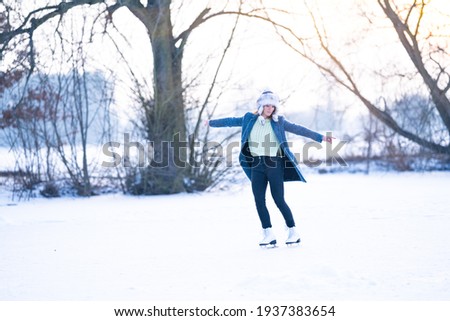 ice skating on the ice of a frozen lake young attractive woman