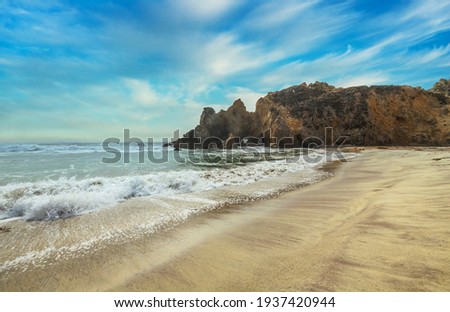 Pfeiffer Beach, in Big Sur is an incredibly picturesque beach, beautiful landscape on the Pacific coast, rocks, sand, ocean and sky. Concept, vacation, photo for postcards, tourist and travel guide.
