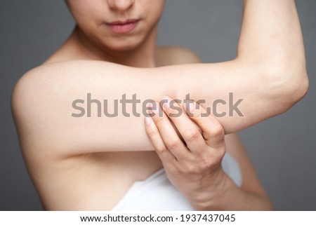 Middle-aged Japanese woman who cares about slack in her upper arm Royalty-Free Stock Photo #1937437045