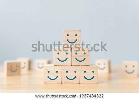 Wooden cube block shape with icon face smiley, The best excellent business services rating customer experience, Satisfaction survey concept Royalty-Free Stock Photo #1937484322