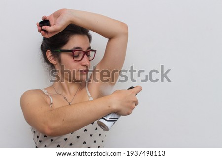 photo taken on white background, american shot, in studio, of woman, passing aerosol deodorant