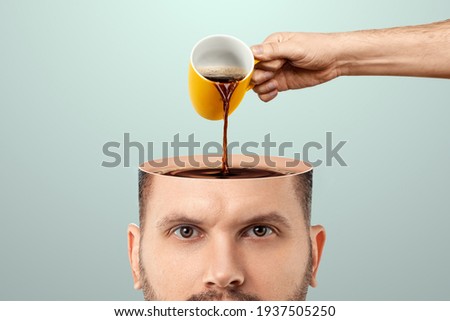 The man's head is open and coffee is poured into it from a cup. Creative background, coffee lover, brain drug, caffeine