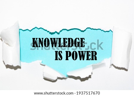 Torn white paper revealing the word knowledge is power