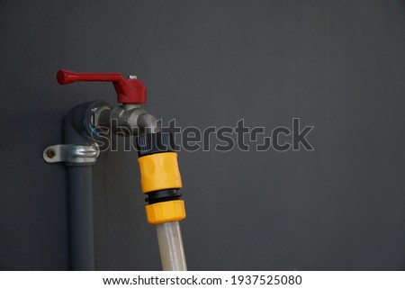                             
Water tap with hose  dark gray background .45 degree angle of view