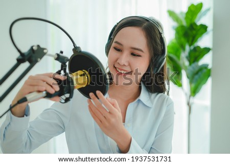 content creator occupation concept. Woman adjusting microphone prepare to record podcast audio in-home office