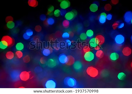 Blurred background, multicolored Christmas, New Year garland out of focus, the theme of the holidays.