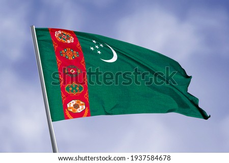 Turkmenistan flag isolated on sky background. close up waving flag of Turkmenistan. flag symbols of Turkmenistan.