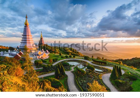 Landscape of two pagoda in Doi Inthanon Mountain with evening orange light splashed at the pagoda in sunset, Chaingmai, Thailand Royalty-Free Stock Photo #1937590051