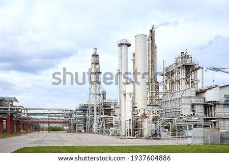 Large-capacity ammonia production workshop. Exterior of modern petrochemical plant with reactors and converters under heavy sky with copyspace. Royalty-Free Stock Photo #1937604886