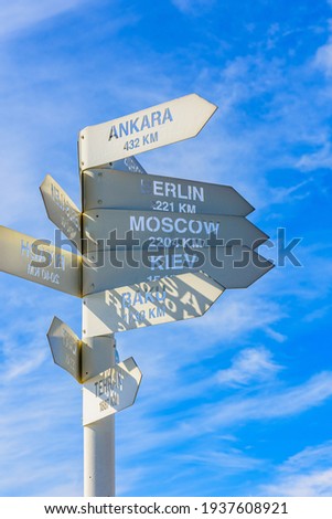 White metal signpost with names of capital cities at summit of Tahtali mountain. Kemer, Turkey