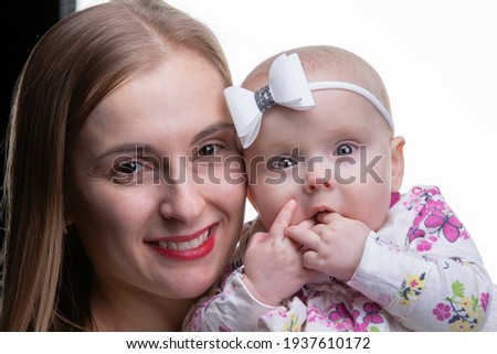 Portrait of a beautiful mother and little daughter.