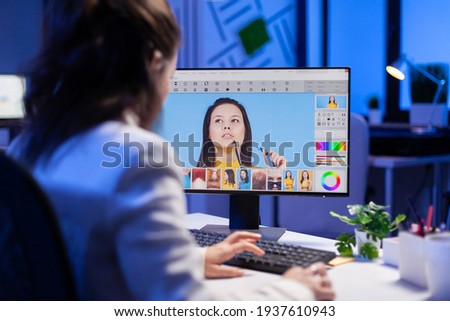 Freelancer retoucher woman working overtime on laptop computer with photo editing software. Graphic editor retouching photos of a client on performance pc before deadline
