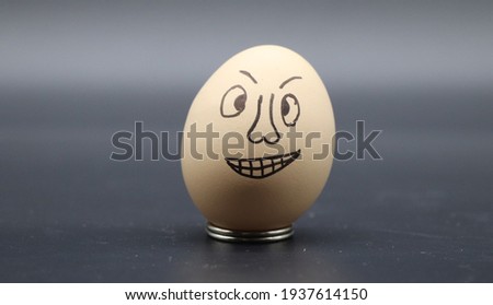 Funny emoji face on egg