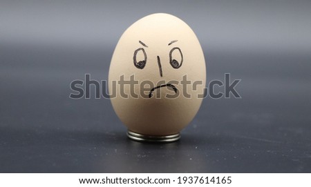 Funny emoji face on egg