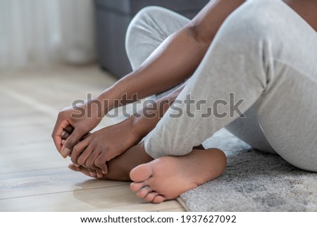 Close up picture of dark-skinned mans legs