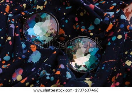 designer glasses kaleidoscope on abstract textile background