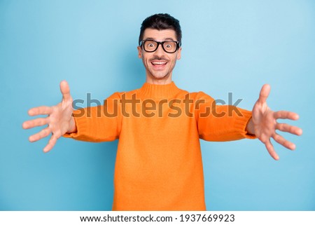 Photo of young handsome man happy positive smile cheerful want to hug you isolated over blue color background