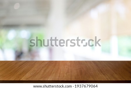 Empty wooden table in front of abstract blurred background of coffee shop . wood table in front can be used for display or montage your products.Mock up for display of product
 Royalty-Free Stock Photo #1937679064