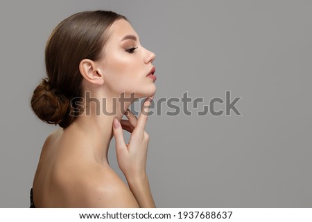 Woman face profile side view. Chin lift pointing with index finger Royalty-Free Stock Photo #1937688637