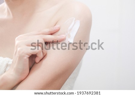 Woman applying natural cream, Woman moisturizing her arm with cosmetic cream, Spa and Manicure concept. Royalty-Free Stock Photo #1937692381