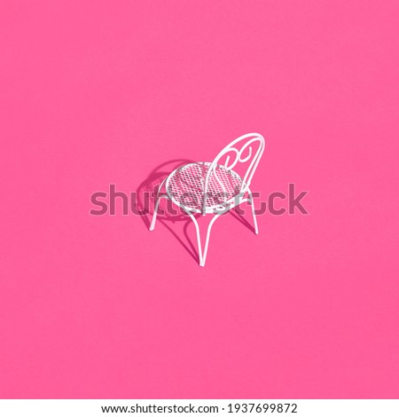 White metal chair on bright pink background. Creative trendy layout with sunshine and hard shadow. Cafe, restaurant, summer minimal concept.