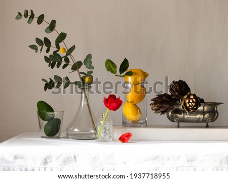 Creative layout with vegetables and flowers in a row on the table. The background is light, the colors are bright. Healthy food concept, poster. High quality photo