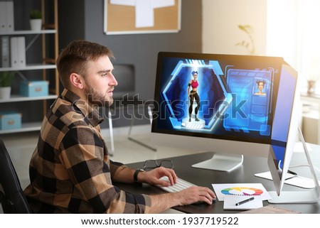 Male video games designer working in studio Royalty-Free Stock Photo #1937719522