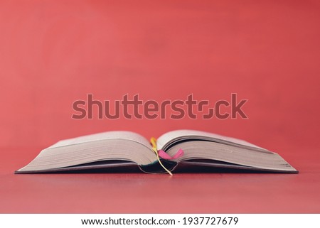 Open book on red background