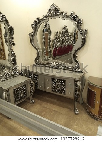 This is the picture of a master piece of art heavy beautiful and luxury dressing table for luxury room in shimmery silver and black colour specially for newly Weds couple room decor interior