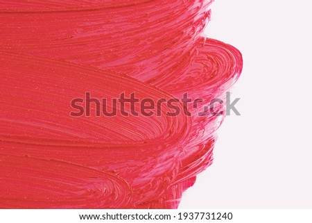 Red cosmetics smear pattern. Beauty product sample closeup. Liquid lipstick cosmetic isolated on white. Swatch matt backdrop. Makeup fashionable creamy texture stroke