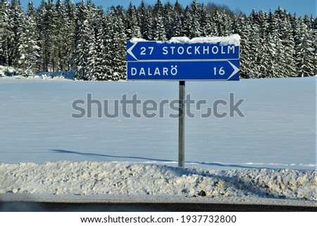 A road sign in Sweden - Stockholm and Dalaro town, travelling in Sweden in winter, snow, direction to the left, right, scandinavian life style, road trip, lost, map, transport transportation, tourism