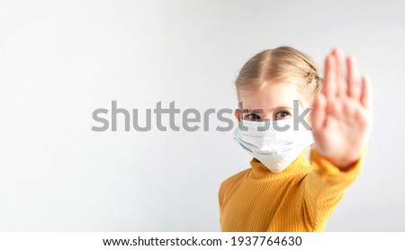 Covid-19. Coronavirus concept. Little girl child wearing mask for protection from disease and showing stop hands gesture for stop coronavirus outbreak. Stay home. Social distancing. Banner