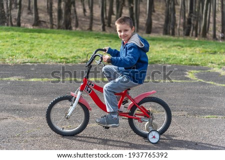 The boy rides a bicycle 