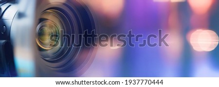  Camera lens close up and blue background  Royalty-Free Stock Photo #1937770444