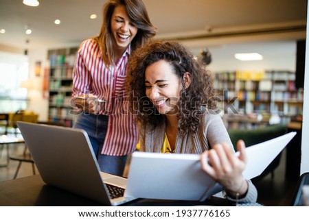 Group of college students studying in the school library.