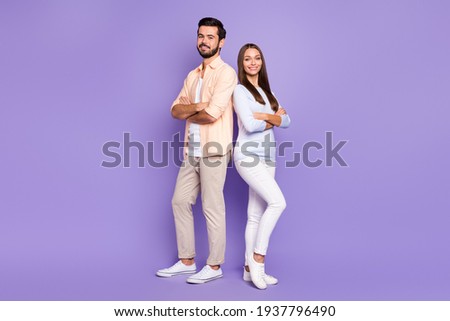 Full size photo of two satisfied friendly persons folded hands beaming smile isolated on violet color background