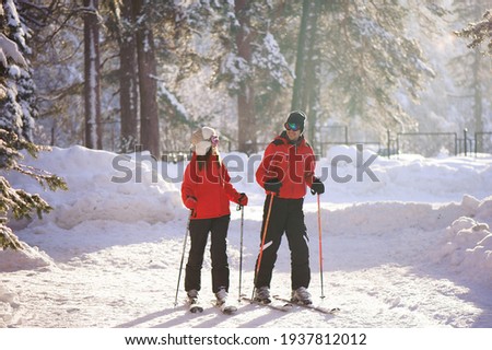 Skiing, snow, winter fun, happy family is skiing in the forest.