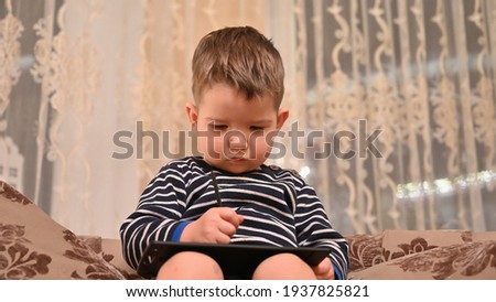 Child draws on a graphics tablet . High quality photo