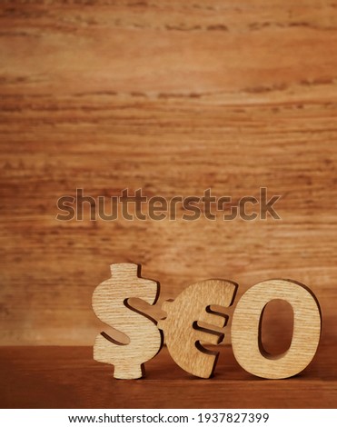 Seo -  wooden word made from  dollar and euro sign. 