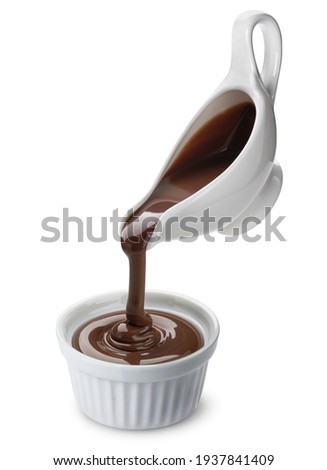 Pouring melted chocolate isolated on white background with clipping path Royalty-Free Stock Photo #1937841409