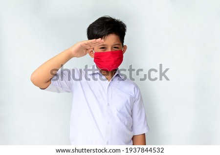 Indonesian male students wearing masks with expressions of respect