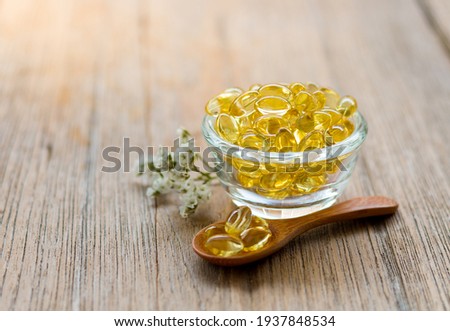 Healthy Vitamins, Omega 3,top view, has a wood background, copy Space,vitamin capsule concept For happiness, put on a wooden spoon to give yellow color. Royalty-Free Stock Photo #1937848534
