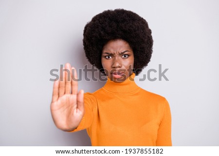 Photo of unhappy dark skin woman make stop sign hand wear orange sweater isolated on grey color background