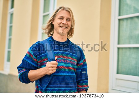 Young scandinavian student man smiling happy standing at the city.