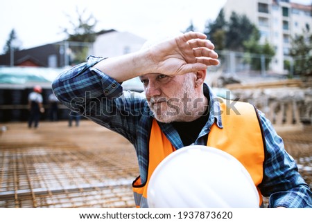 Portrait of a worker, an engineer resting after hard work on a construction site