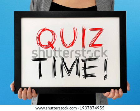 Quiz time concept, hand holding a signboard on blue background