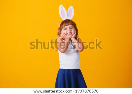 Little blonde girl with bunny ears. Happy Easter concept!
