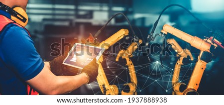 Smart industry robot arms for digital factory production technology showing automation manufacturing process of the Industry 4.0 or 4th industrial revolution and IOT software to control operation . Royalty-Free Stock Photo #1937888938